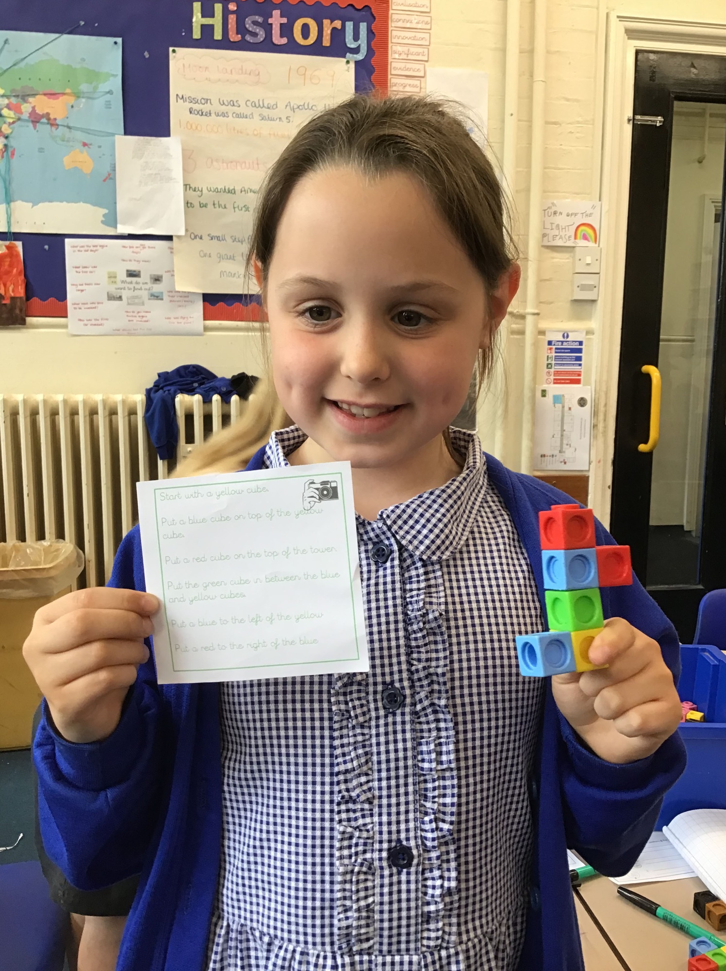 Child holding her tower made out of multilink
