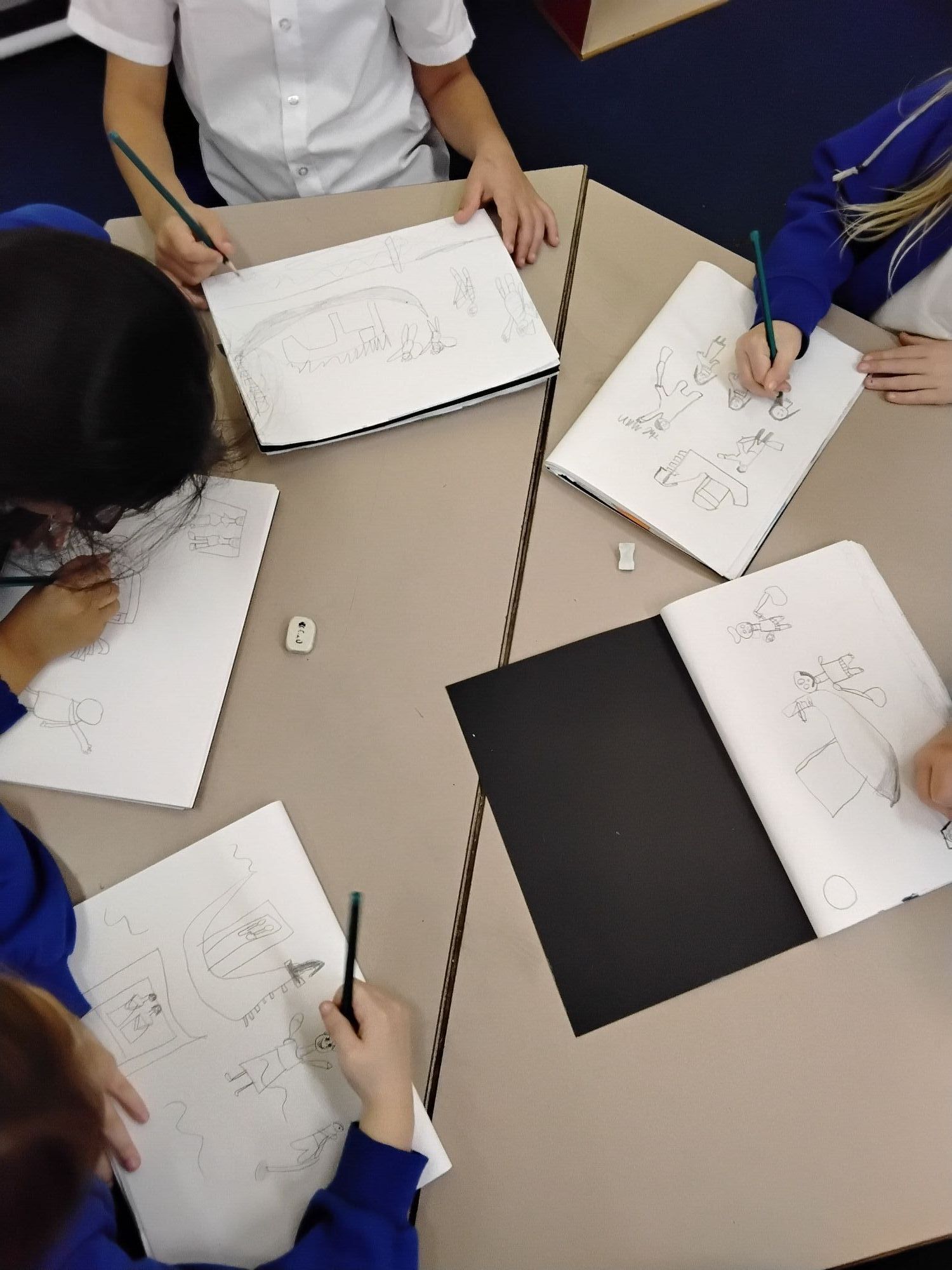 Children drawing a picture of a canal