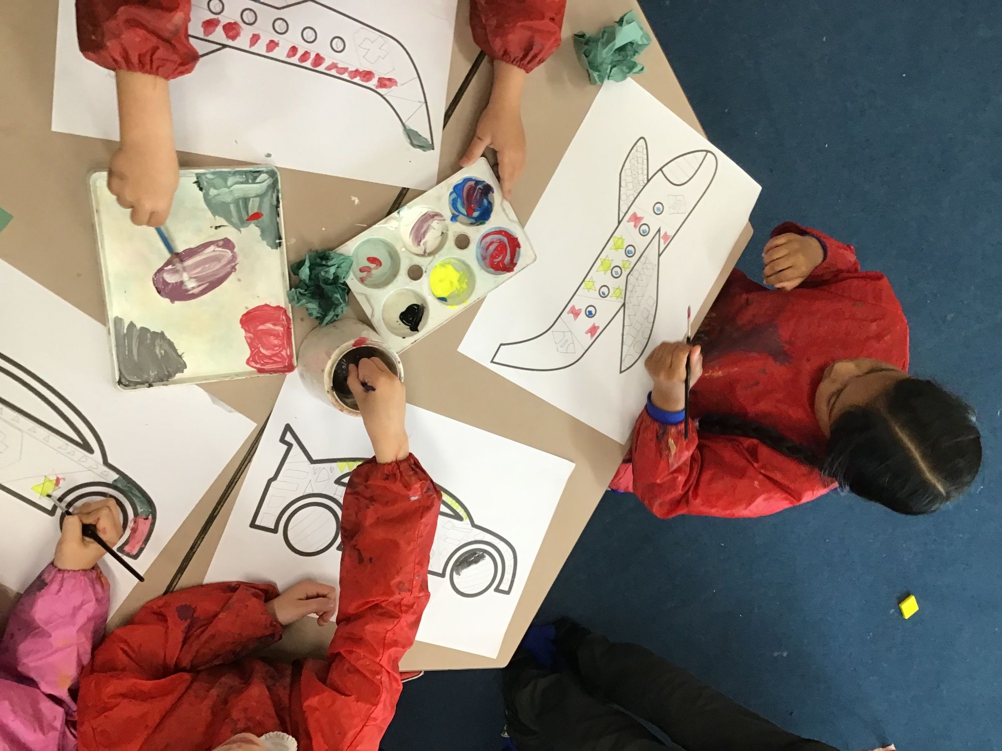 Children painting vehicles