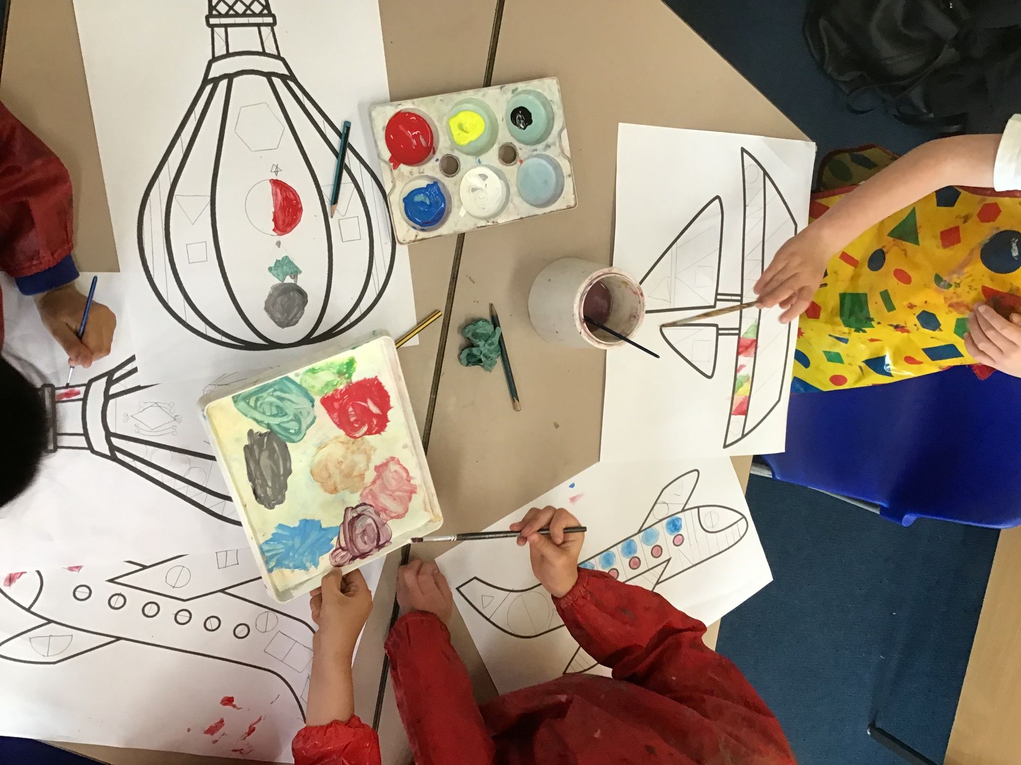 Children painting vehicles