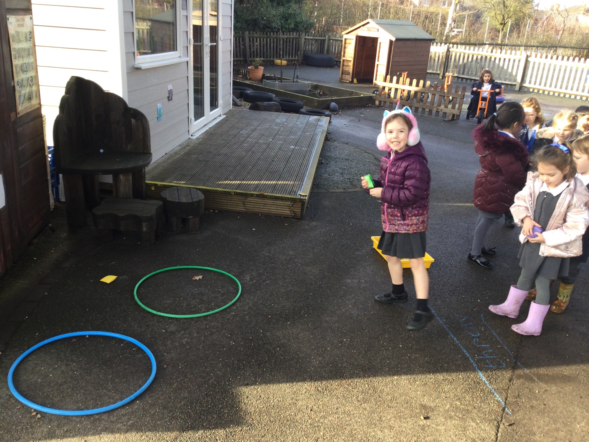 Throwing beanbags into the correct hoop