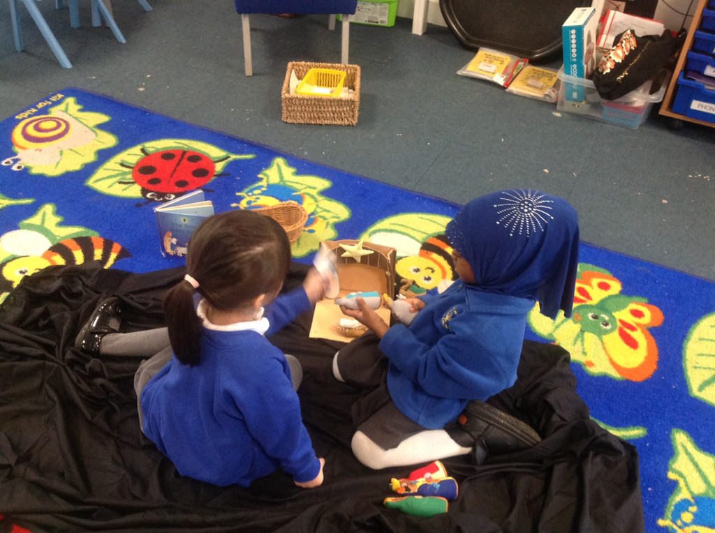 Children using figures to act out the nativity story