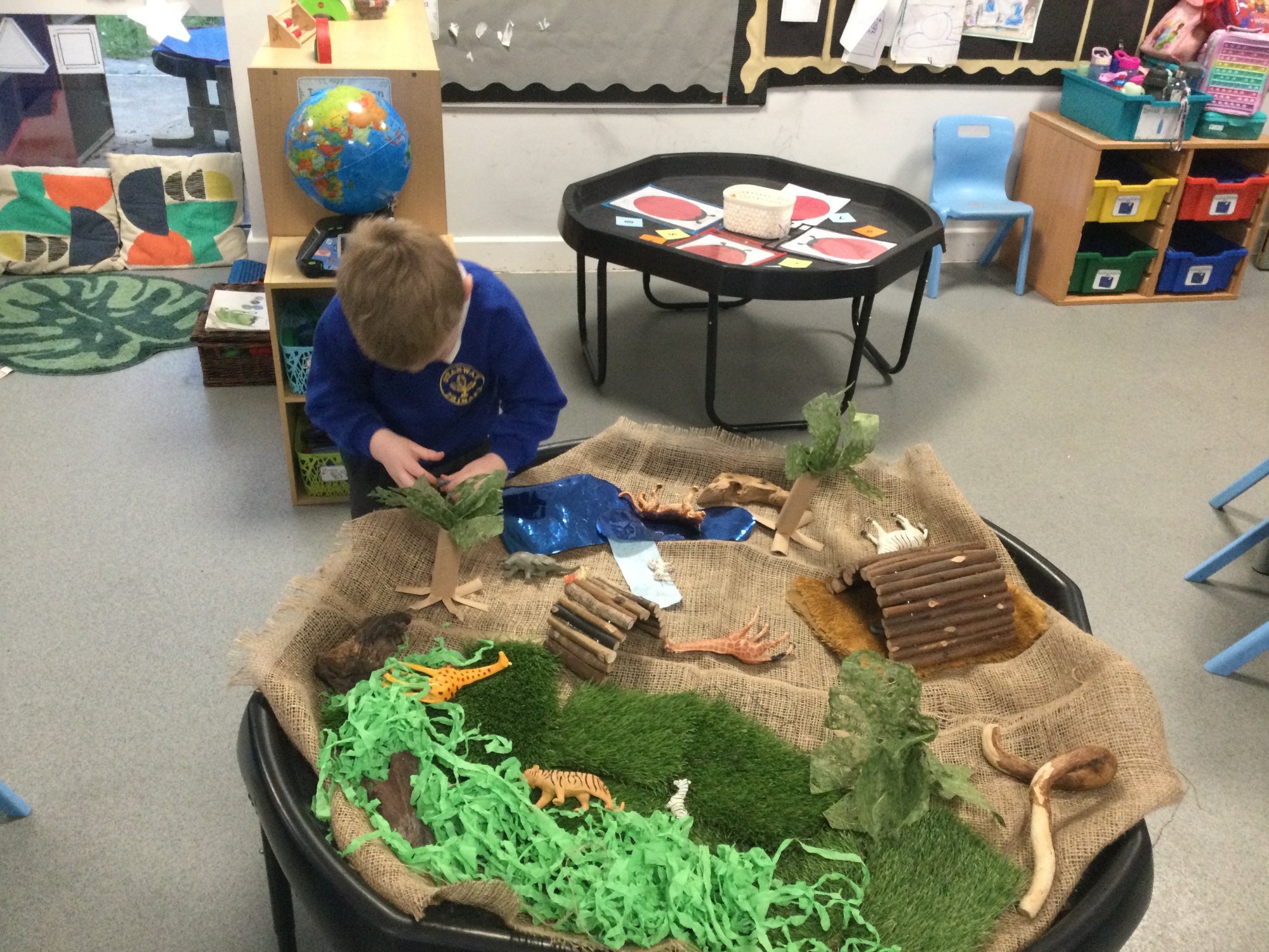 A child playing with our small world set up 